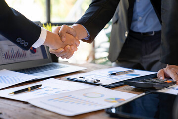 Handshake as successful negotiation ending, close-up. Unknown business people shaking hands after contract signing in modern office