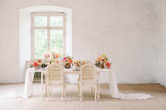 Table with flowers in light room