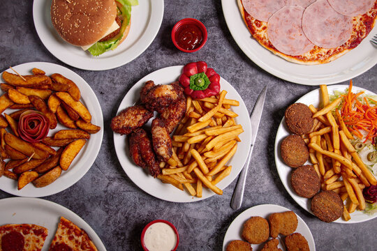 Different fast food dishes on table