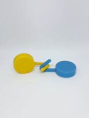 Two round blue and yellow clothes hook hangers that go hand in hand.