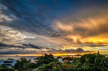 Stormy tropical skies at a beach near Pattaya, Thailand during the monsoon rainy season can produce spectacular sunsets