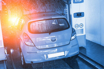 Automatic car wash. Auto brush washer clean blue car on automatic carwash station. Automatic car wash cleaning service.