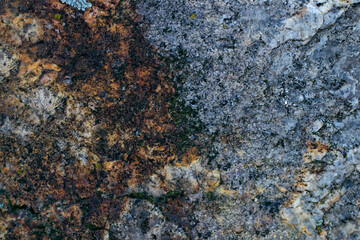 Raw gray granite rock texture background. Fragment of natural stone wall