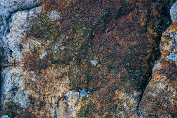 Raw gray granite rock texture background. Fragment of natural stone wall