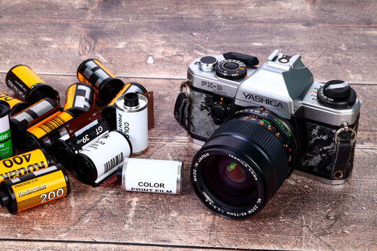 Old battered SLR camera with 35mm film rolls