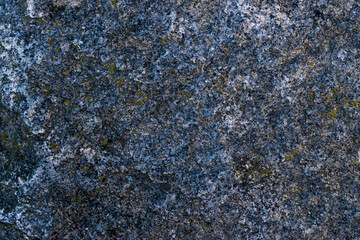 Raw gray granite rock texture background. Fragment of natural stone wall