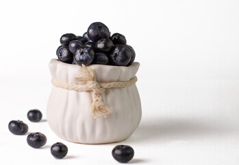 Blueberry. Berries of fresh and juicy blueberries on a white background. Selective focus.