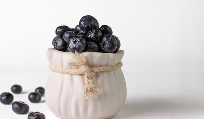 Blueberry. Berries of fresh and juicy blueberries on a white background. Selective focus.