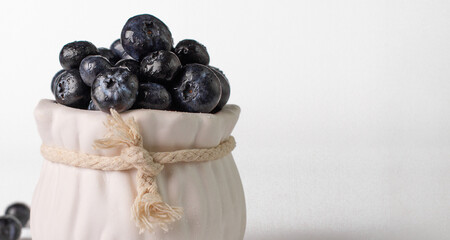 Blueberry. Berries of fresh and juicy blueberries on a white background. Selective focus.