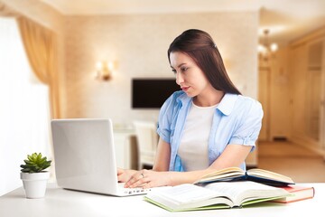 Online education, e-learning concept. Clever positive girl successful student, studying from home using laptop