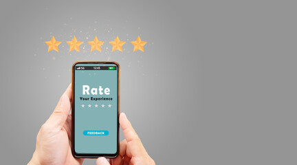 Customer feedback concept, hand holding smartphone that showing yellow five stars for giving best service ranking