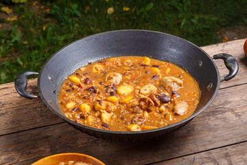 Chelnt with chicken in a large cast iron skillet on the table.