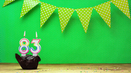 happy birthday with decorations festive garlands with muffin on a green background with polka dots....