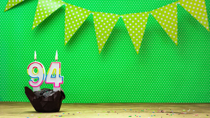 happy birthday with decorations festive garlands with muffin on a green background with polka dots....