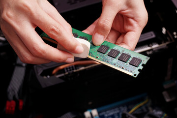 Cleaning a random access memory or RAM using an eraser. 
