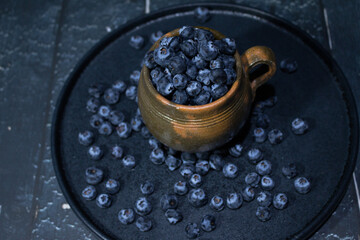 fresh blueberries in earthenware brown mug
