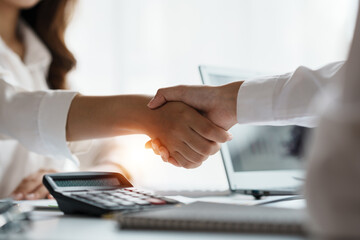 Business success. Business people shake hand to confirm the agreement to do business with joint investment in the company.