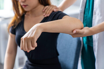 The doctor counsels the patient about pain in the muscles of the arms and elbows. office syndrome...
