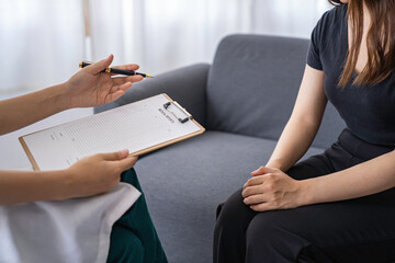 Female doctor and patient giving consultation and diagnosis by sitting and talking. at the table...