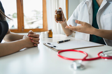 Doctors follow up on treatment, consult patients, and perform diagnostic work while writing prescription information sheets in clinics or hospital offices. medical and health concepts
