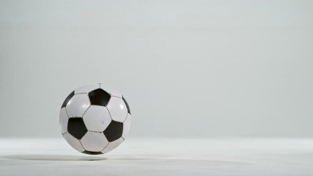 Super slow motion of jumping soccer ball on white background. Filmed on high speed cinema camera, 1000fps. Speed ramp effect.