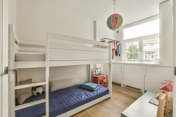 Interior of modern kid bedroom with bunk bed and shelves with various toys at home