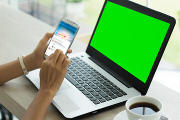 businesswoman working in office interior on pc on desk, looking at green screen. Office person using laptop computer with laptop green screen,	
