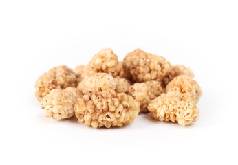Dried mulberries in a pile, isolated. Dehydrated organic fruit used as snack, granola or in baking. Superfood. Selective focus with defocused pile of mulberries.