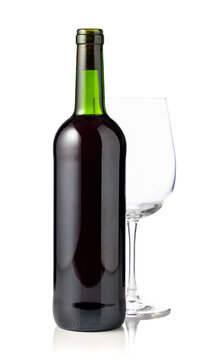 Bottle and glass of red wine are isolated on white.