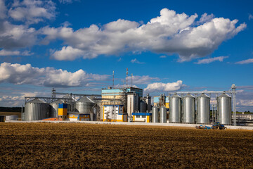 Agricultural Silos. Storage and drying of grains, wheat, corn, soy, sunflower against the blue sky...