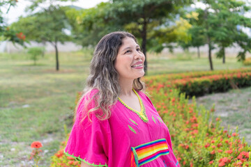 Fototapeta premium Portrait of young indigenous woman standing in a park