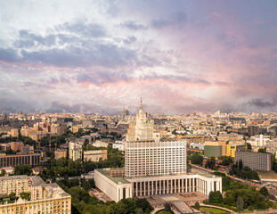Aerial view of Moscow against the background of a romantic evening sky with clouds and rays of the sun. Government House of the Russian Federation (White House)-written in Russian, Russia