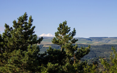 Panoramic view of the green valley and the snow-covered Mount Elbrus against the blue sky from the observation deck in Kislovodsk Russia