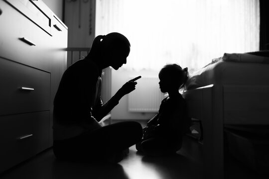 Mother correcting, disciplining her child for bad behavior	