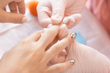 Manicure salon, nail design on shiny nail. Fashionable multicolored manicure. Professional manicure in beauty salon. Hygiene and care for hands. Beauty industry concept