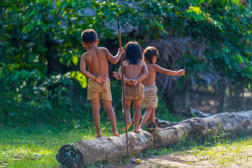Naklejka na ściany i meble Indigenous children in the Amazon rainforest
