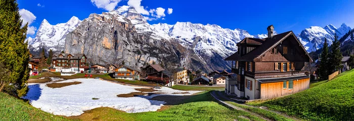 Foto op Canvas Switzerland nature and travel. Alpine scenery. Scenic traditional mountain village Murren surrounded by snow peaks of Alps. Popular tourist destination and ski resort © Freesurf