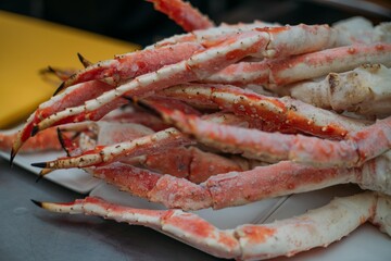 Legs of fresh red Kamchatka crab on the table in the restaurant kitchen. Freshly frozen crab meat for cooking