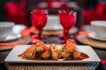 A ready-made dish of fresh red Kamchatka crab legs on the table in the restaurant hall.  Cooked crab meat in a shell on a plate