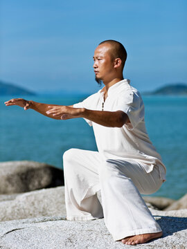 Man Practices Qi Gong at sunrise. Koh Samui, Thailand. 