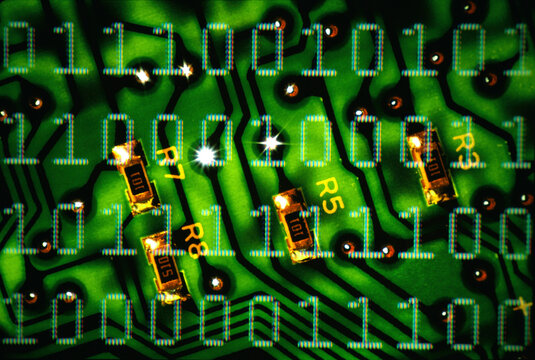 Binary code superimposed over a circuit board