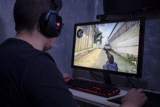 Santos, Brazil - September 7, 2022: Gamer man playing Counter Strike global offensive (csgo) video game on PC. Counter Strike is an online shooter game (FPS) developed by Valve. 
