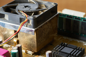 Old motherboard covered in dust and dirt. Close-up.