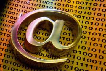 Close-up of a @ symbol on binary codes