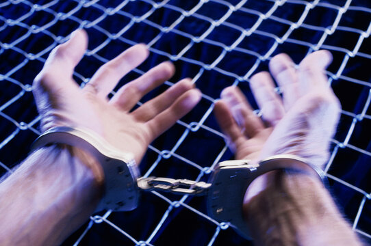 Close-up of a person's hands in handcuffs