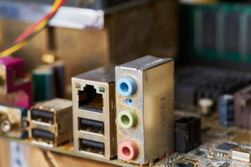 Old motherboard covered in dust and dirt. Close-up.