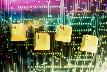 Close-up of key spelling HTML on a circuit board