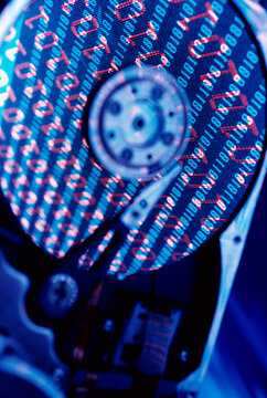 Close-up of a hard drive with binary code superimposed over it