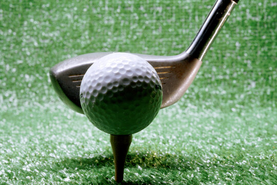 Close-up Of A Golf Club Next To A Golf Ball