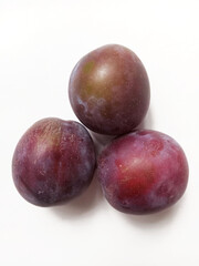 ripe juicy plums on white background	